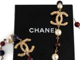 a close up of a box with a necklace and a pair of earrings