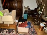 a room with boxes and a rug on the floor