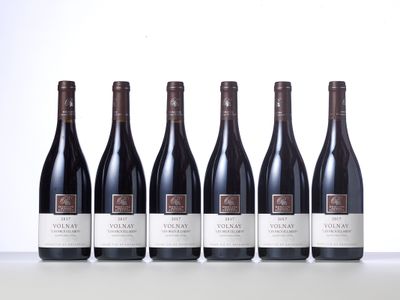 six bottles of red wine lined up in a row