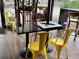 tables and chairs in a restaurant with a view of the outside