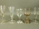 five wine glasses sitting next to each other on a table