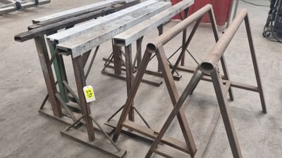 several pieces of metal are stacked on top of each other in a warehouse