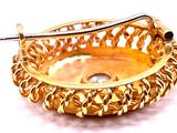 a gold plated bowl with a diamond in it