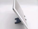 a white tablet computer sitting on a stand on a table