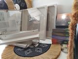 a microwave sitting on top of a table next to a pile of books