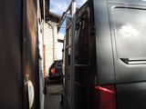 a black van that is parked next to a building