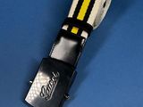 a close up of a belt with a yellow and black stripe on it