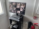 a desk with a computer monitor and a printer on it