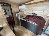 a small kitchen with a sink and a refrigerator in it