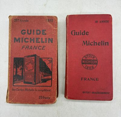 two books on a white surface one is red and the other is black