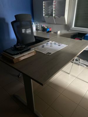 a desk with a laptop and a printer on it