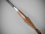 a close up of a knife with a wooden handle on a table