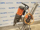 an image of a drill on a tripod in front of a wall