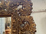 a mirror that is sitting on a table in a room