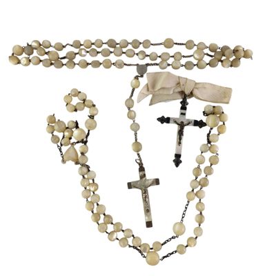 a close up of a rosary and a cross on a white background