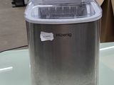 a small ice maker sitting on a table in a warehouse