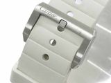 a close up of a white watch on a white surface
