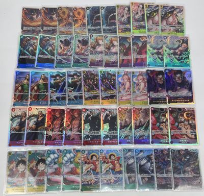 a large collection of anime trading cards on a table