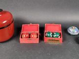 a red box with dice pieces and a red container with dice pieces