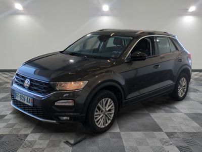 a black volkswagen suv parked on a checkered floor in a garage