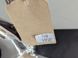 a tag on the handle of a faucet that is attached to the handle of a faucet