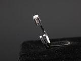 a close up of a silver ring on a black surface