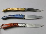three different types of knives sitting on a table