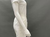 the mannequin is wearing a white dress and hat