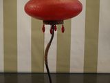 a red lamp that is sitting on a table
