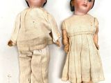 two dolls that are standing next to each other