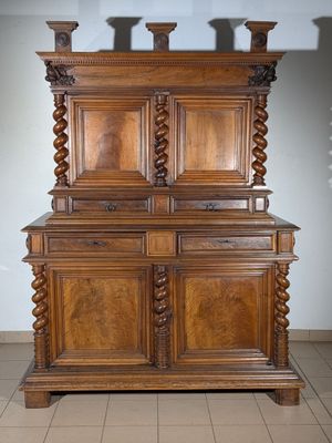 a large wooden cabinet with two doors on top of it