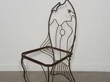 wrought iron chair in the shape of a chair with a seat and backrest