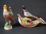 two figurines of birds sitting on top of each other