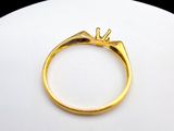 an image of a gold ring with a diamond on top