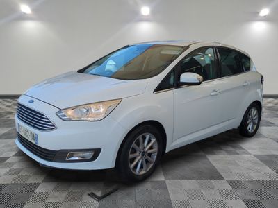 a white ford c - max parked on a checkered floor