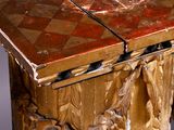 a wooden table that has a marble top on it