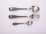 three silver spoons and a fork on a white surface
