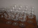 many empty wine glasses sitting on a wooden table