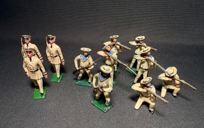 several figurines of men in military uniforms are posed on a table