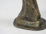 bronze statue of a woman holding a bird on a white surface