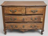 a wooden chest of drawers with many drawers on top of it