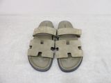 sandals on a bed with a white sheet and a white sheet