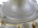 a close up of a metal object on a white surface