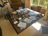 a table with a lot of papers on it in the room