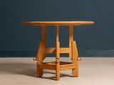 a small table with a wooden top on a concrete floor