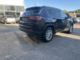 a black jeep is parked in front of a building