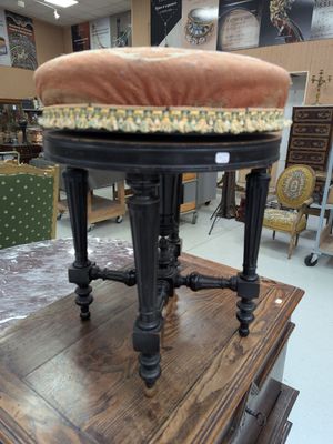 a stool with a cushion on top of it in a store