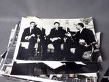 several black and white photos of men in suits sitting on a couch