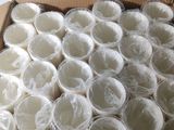 une boîte remplie de gobelets en plastique emballés dans du film plastique