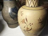two vases that are sitting on a table
